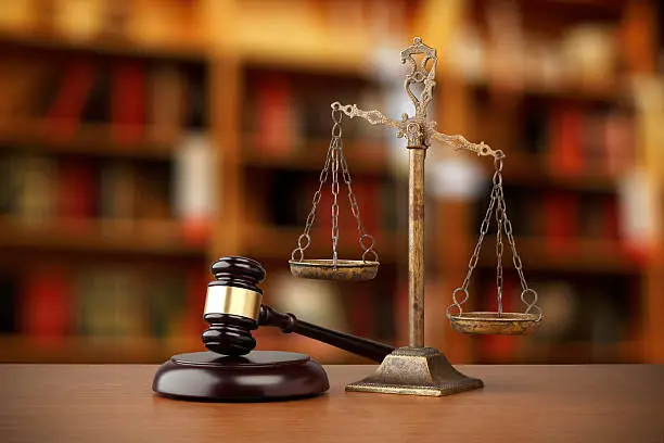 Gavel And Scales Of Justice On Desk In Law Office