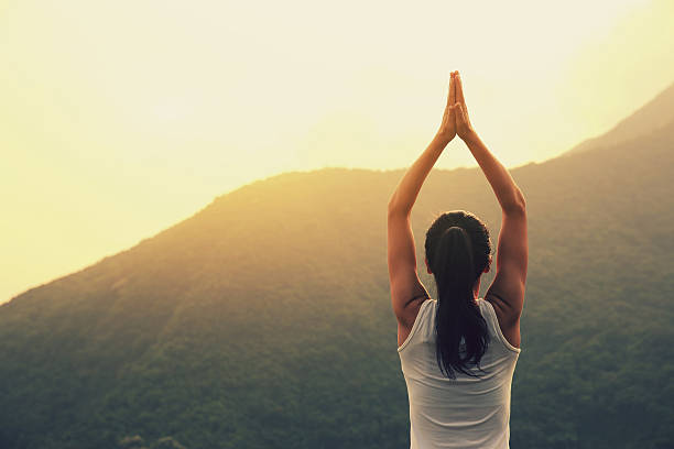 istock young woman practice yoga at mountain peak cliff 531606190