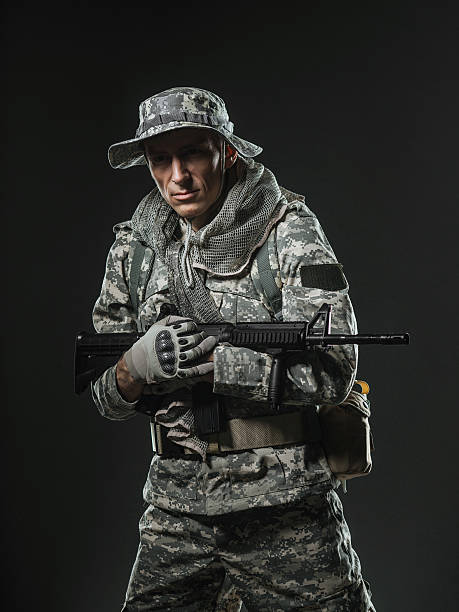 istock soldier man with Machine gun on a  dark background 531606792