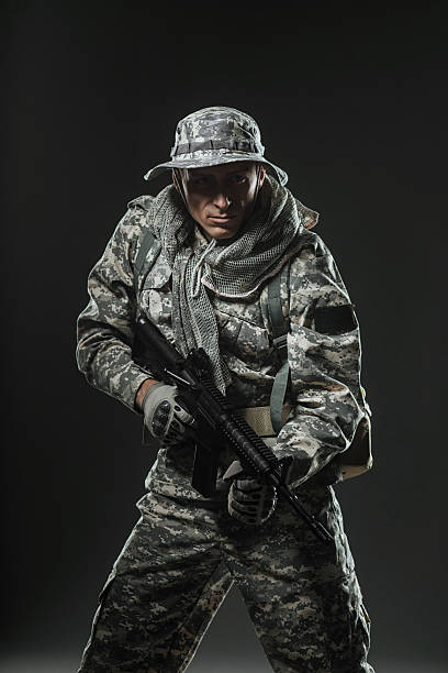 istock soldier man with Machine gun on a  dark background 531606858