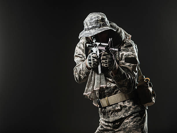 istock soldier man with Machine gun on a  dark background 531606958