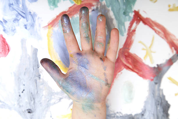 istock Children's hand against children's drawing 531607188