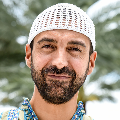 Smiling mature middle eastern man posing looking at the camera