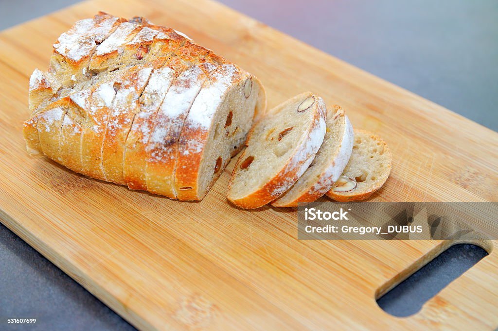 Healthy whole grain bread homemade named sports bread Close-up of sliced homemade whole grain bread on wooden cutting board. This bread is called "Sports Bread" because it contains lots of vitamins, nut, cereal, dried raisin grape, dried fruit... Bread Stock Photo