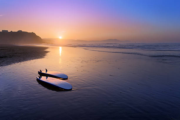 Sopelana beach with surfboards on the shore Sopelana beach with surfboards on the shore at sunset sopelana stock pictures, royalty-free photos & images