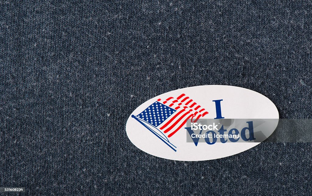 "I voted" sticker Closeup of an American "I voted" sticker placed on a navy shirt. Voting Stock Photo