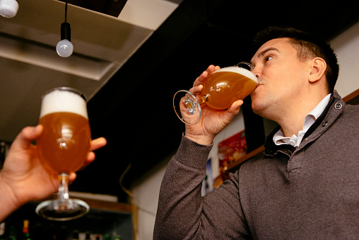 Binge drinking beer in pub