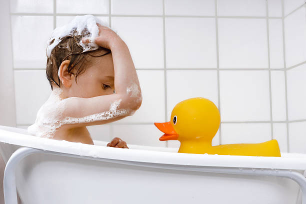 istock small boy washing hair in a bathub 531609949