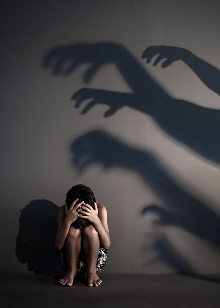 Dark Shadows Fearful shadows scaring a child. sexual violence stock pictures, royalty-free photos & images