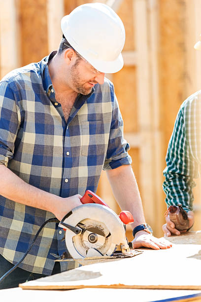istock Man uses saw at job site 531611758