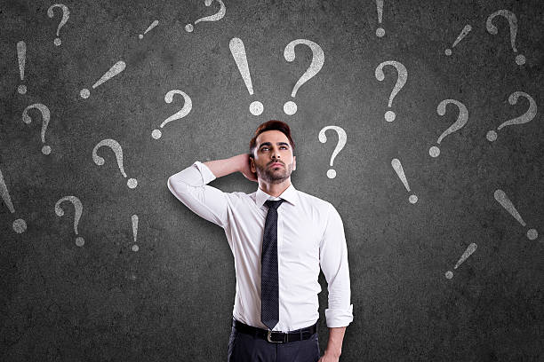 istock Confused businessman with question marks and exclamatory signs 531612840