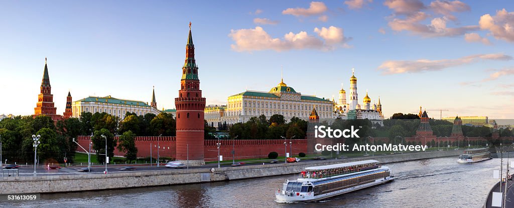 Moscow Kremlin night lights Panorama - Moscow Kremlin at summer evening. Moscow-river and tourist pleasure boats. View from bridge. Kremlin Stock Photo