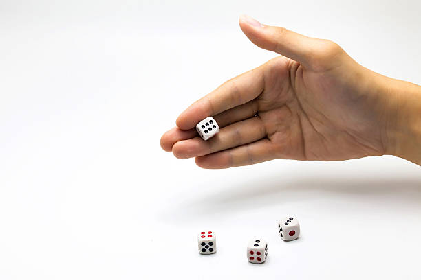 istock Human hand ready to roll the dice on white isolated 531613890