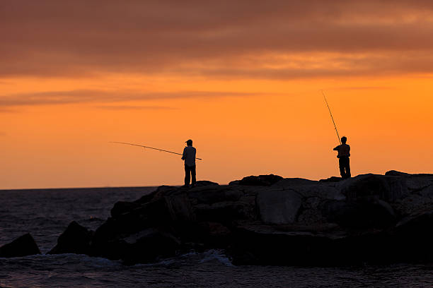 istock Silhouette of Men fish on the pier 531613906