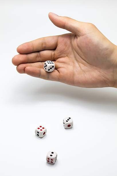 istock Human hand ready to roll the dice on white isolated 531613912
