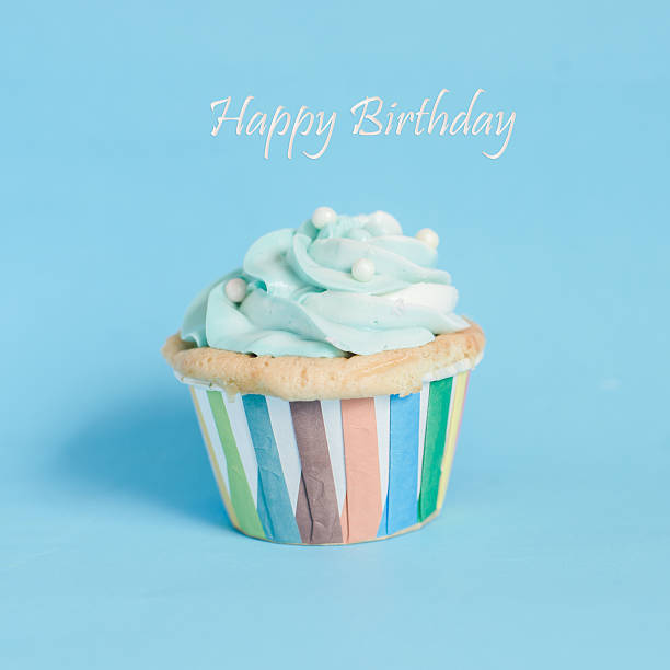 istock Pearl birthday cupcake with butter cream icing on blue pastel 531615024