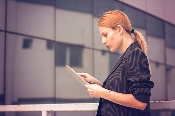 istock Formal dressed woman with digital tablet 531617158