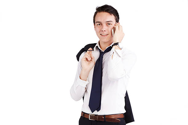 Young Caucasian businessman smiling with mobile phone stock photo