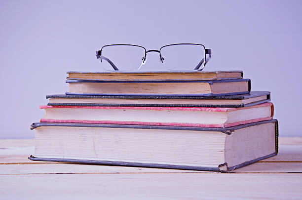 istock glasses on stack of book in vintage tone 531618672