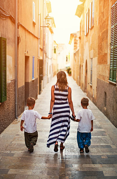 istock Mother with two sons visiting mediterranean town. 531620542
