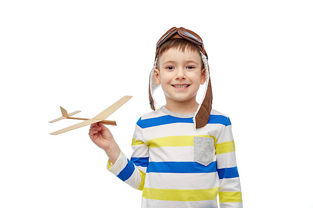 istock happy little boy in aviator hat with airplane 531621704