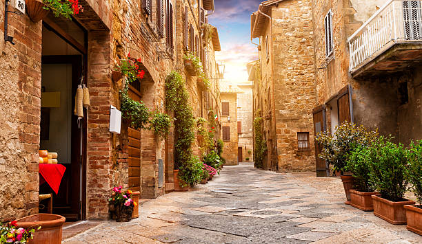 Colorful street in Pienza, Tuscany, Italy Colorful street in Pienza with many decoration flowers and trees, Tuscany, Italy siena italy stock pictures, royalty-free photos & images