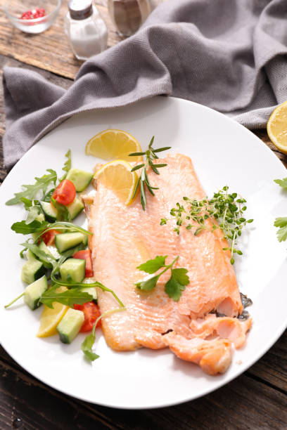 istock baked fish and salad 531623290
