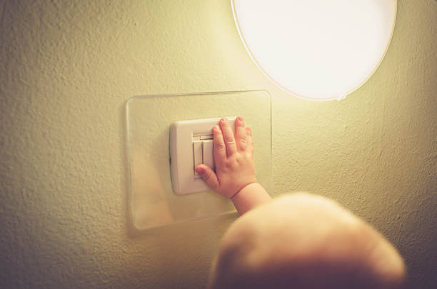 istock Baby child switching on / off the light 531624326