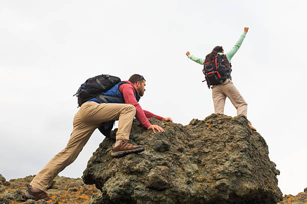 istock Couple standing on top of rocks 531624692
