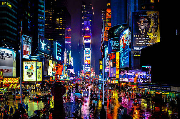 Times Square Times Square in New York on a rainy night. times square stock pictures, royalty-free photos & images