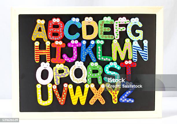 Colorful Magnet Wooden Alphabet On Blackboard Stock Photo - Download Image Now - 2015, Alphabet, Black Color