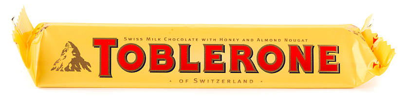 Ankara, Turkey - January 08, 2015: Studio shot of Swiss chocolate bar Toblerone isolated on white background. Toblerone is a Swiss chocolate bar brand owned by American Mondelez International, Inc., produced in Bern and is well known for its distinctive prism shape.