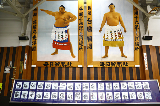 Tokyo, Japan - December 29, 2014: pictures of famous Sumo champions in a subway station. Below them the handprints of many other champions.