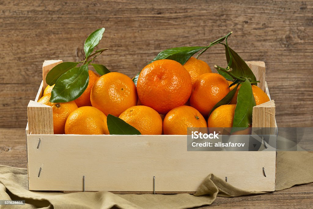 Tangerines Tangerines or Mandarin orange in wooden box. Selective focus. 2015 Stock Photo