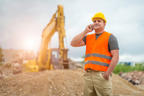 Construction worker on the phone at the construction site