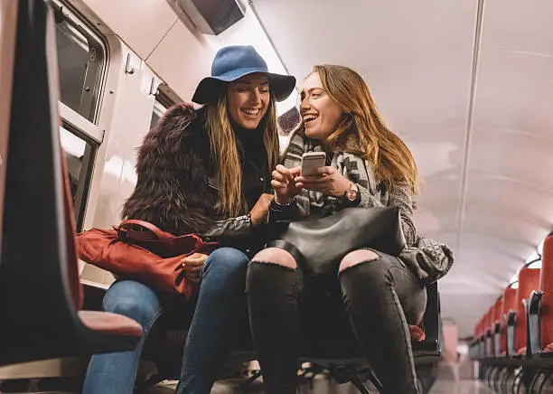 Photo of Women laughing in the subway