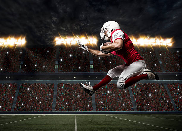 Football Player Football Player with a red uniform Running on a stadium. Touchdown stock pictures, royalty-free photos & images