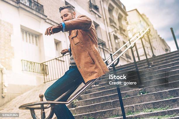 Bearded Man Sliding Down The Iron Balustrade Of Monmartre Stairs Stock Photo - Download Image Now