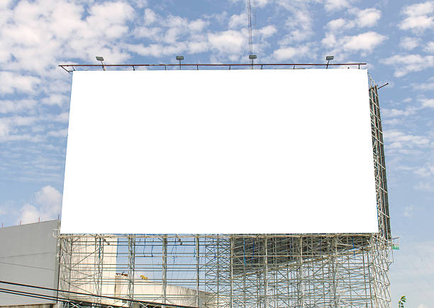 istock large blank billboard on road with city view background 531631375