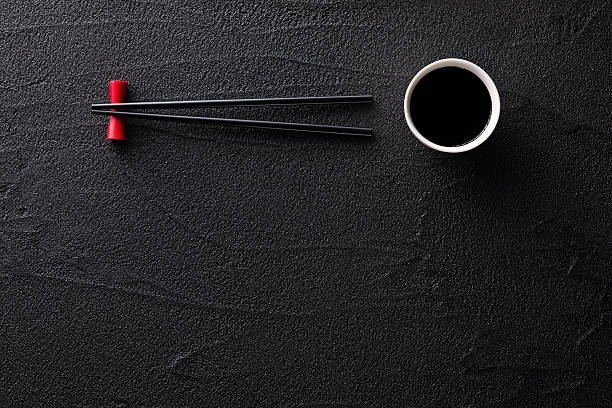 istock Chopsticks and bowl with soy sauce on black rock 531639027