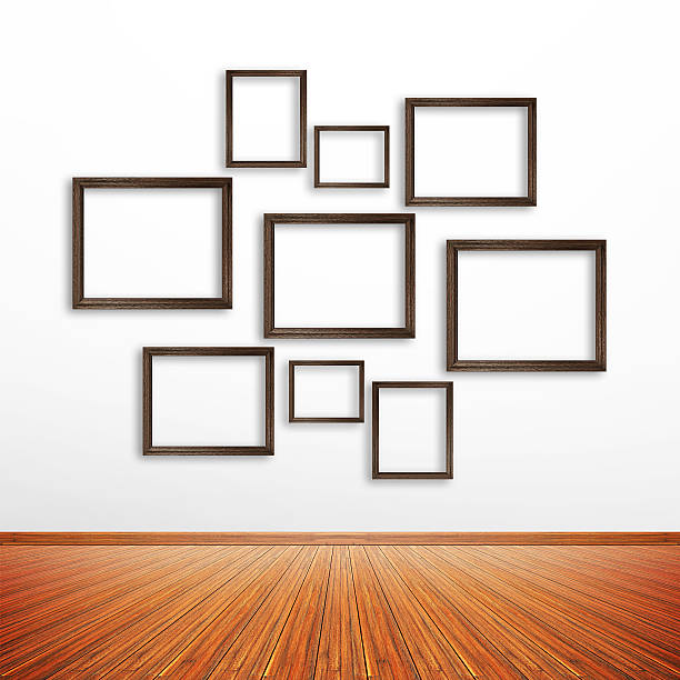 istock Wooden photo frames on white wall inside the room 531639539