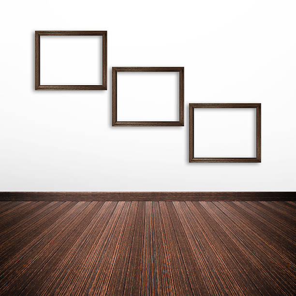 istock Wooden photo frames on white wall inside the room 531639545
