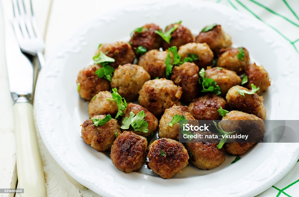 meatballs grilled with parsley meatballs grilled with parsley on a white wood background. tinting. selective focus 2015 Stock Photo