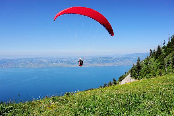 Paraglider above the French THULLON mountain 004 Evian, France - June 21, 2014: Paraglider above the French THULLON mountain. evian les bains stock pictures, royalty-free photos & images