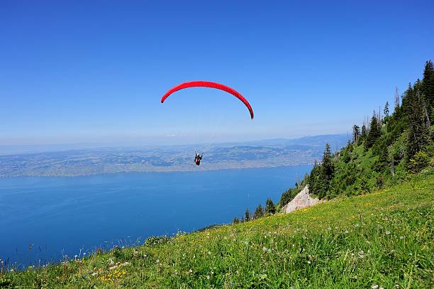 Paraglider above the French THULLON mountain 011 Evian, France - June 21, 2014: Paraglider above the French THULLON mountain. evian les bains stock pictures, royalty-free photos & images