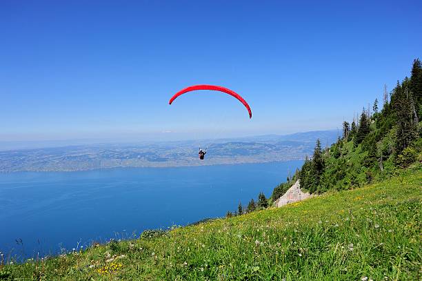 Paraglider above the French THULLON mountain 013 Evian, France - June 21, 2014: Paraglider above the French THULLON mountain. evian les bains stock pictures, royalty-free photos & images