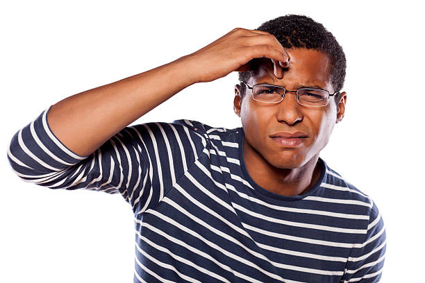 istock Unsure dark-skinned young man with glasses trying to focus 531642789