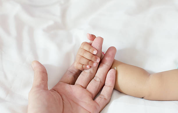istock Baby 5 months hold your hand father 531643197