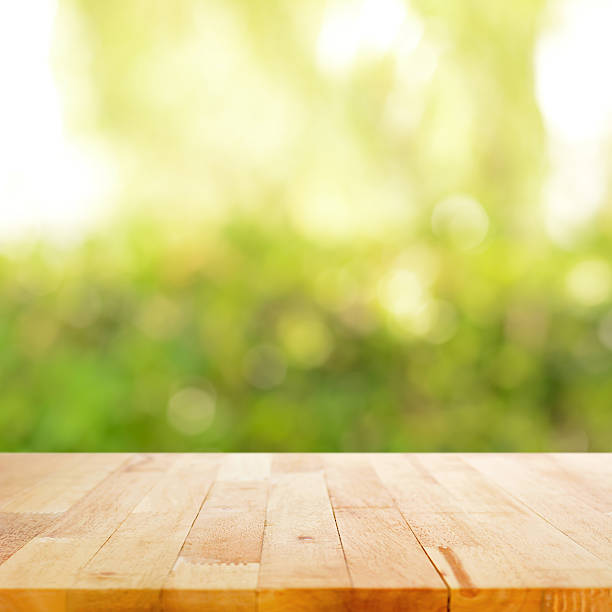 istock Wood table top on blurry green abstract background 531644757