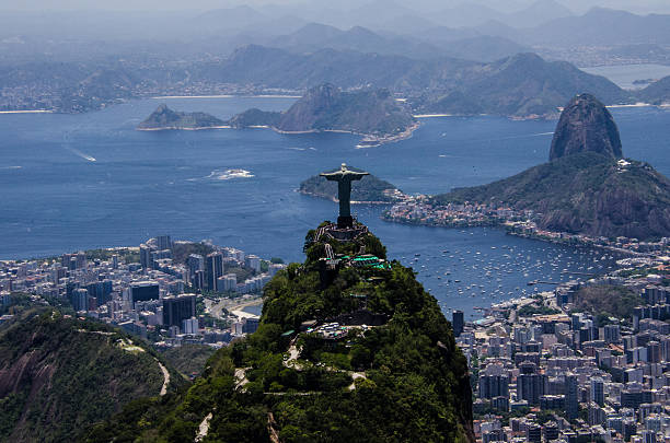 Open arms over guanabar Christ the Redeemer with the background the bay of granabara cristo redentor rio de janeiro stock pictures, royalty-free photos & images
